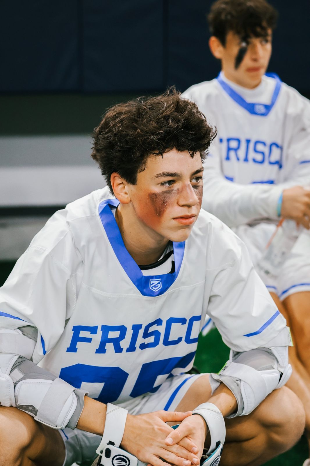 Frisco lacrosse player on the sideline